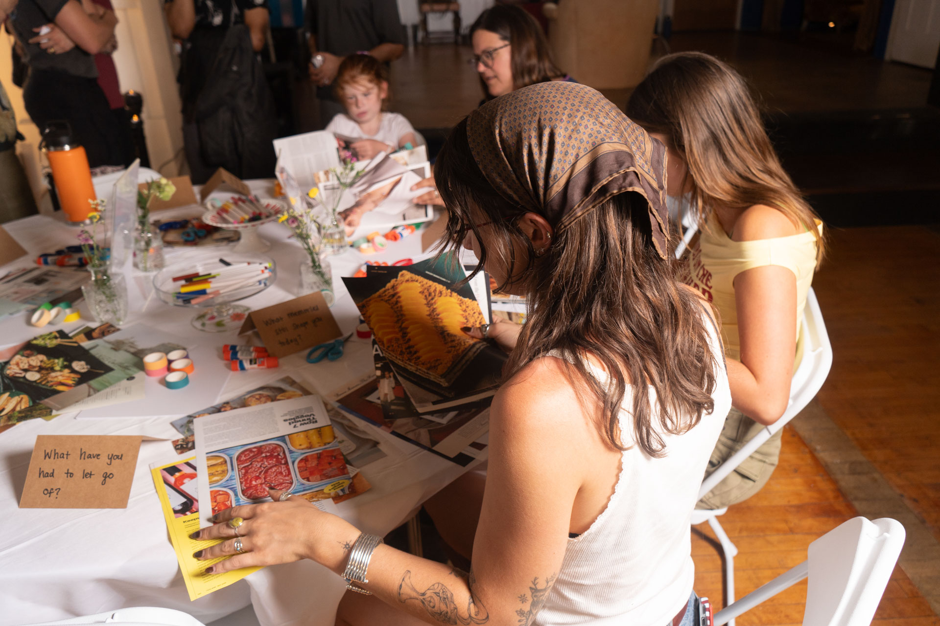 Members cutting and arranging magazine clippings at a collage workshop