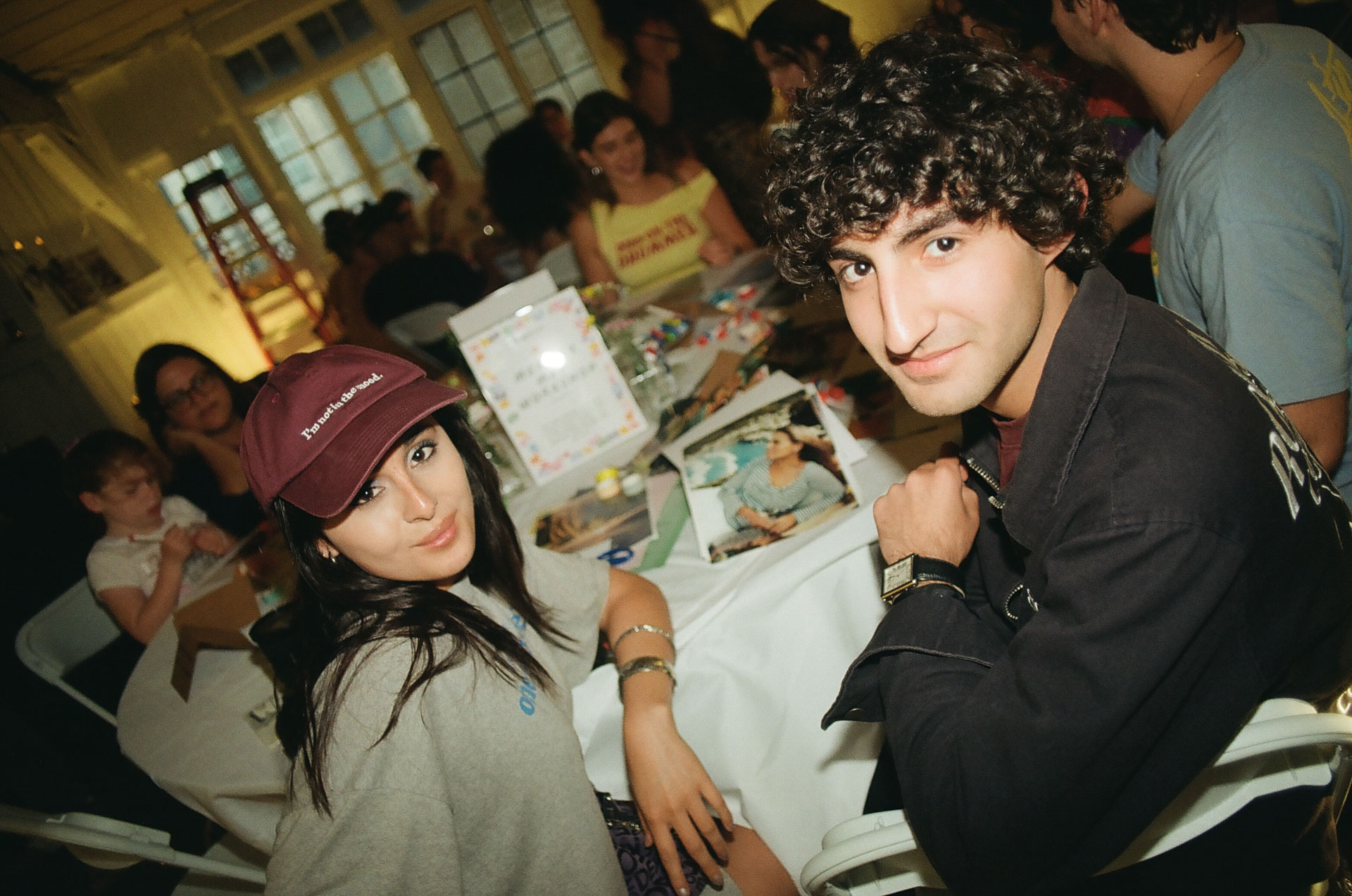 Members seated together at a long table during a PLAYE event